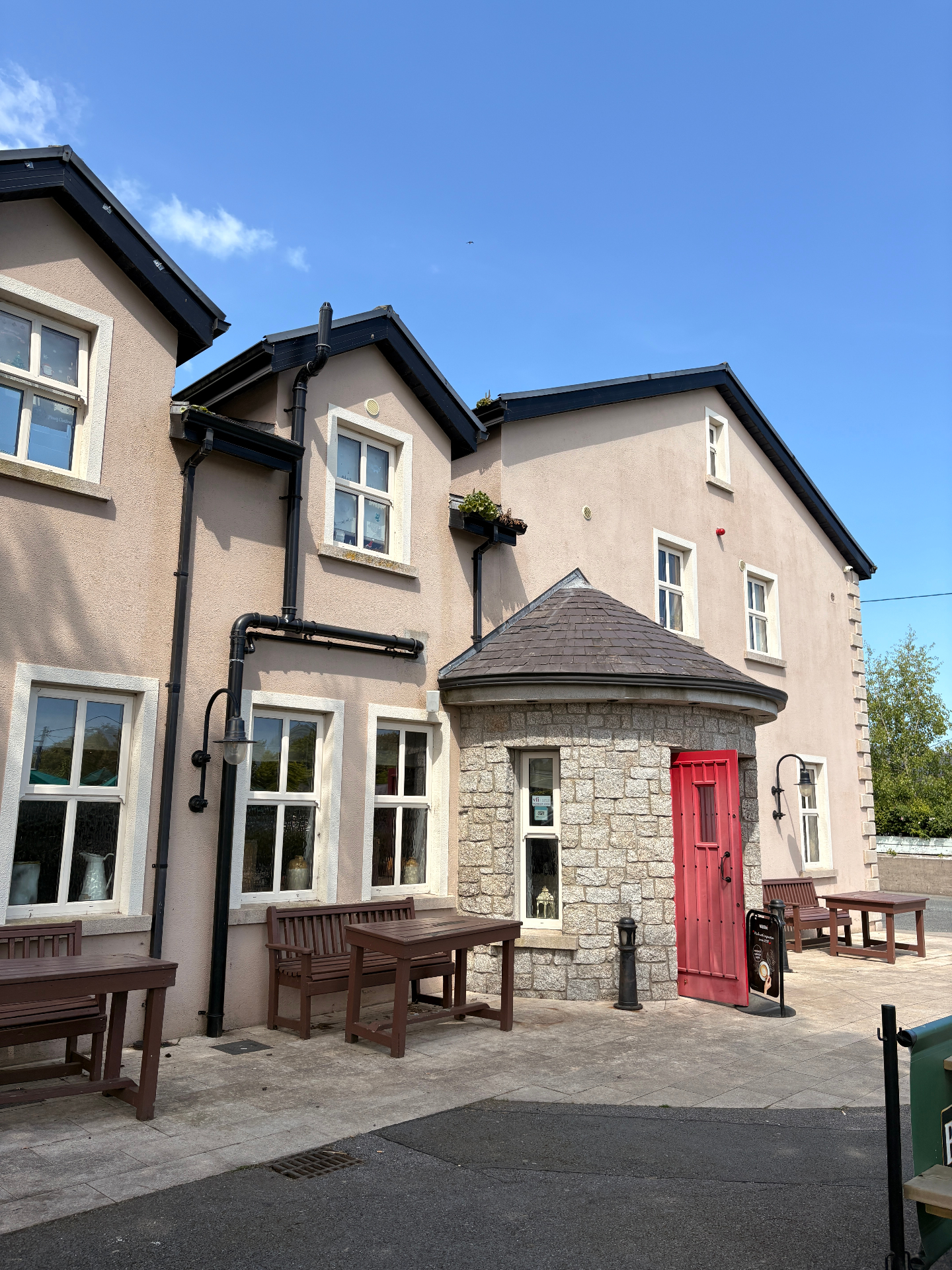 The Castle Inn exterior with red door and stone turret